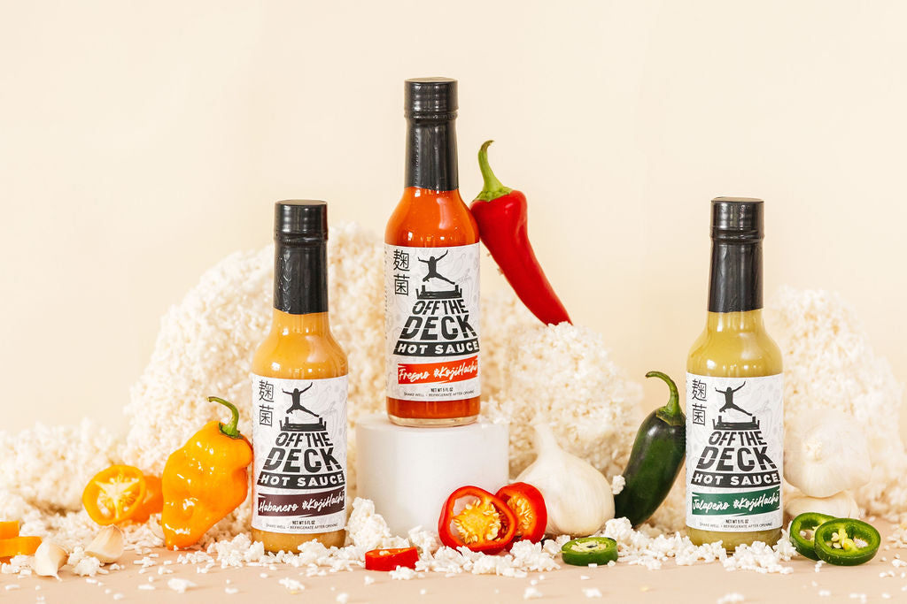 Koji Flight, three koji-fermented Off The Deck hot sauces with fresh peppers